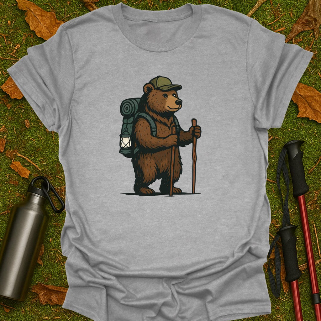 Gray t-shirt with a bear graphic holding a lantern and walking stick on grass.