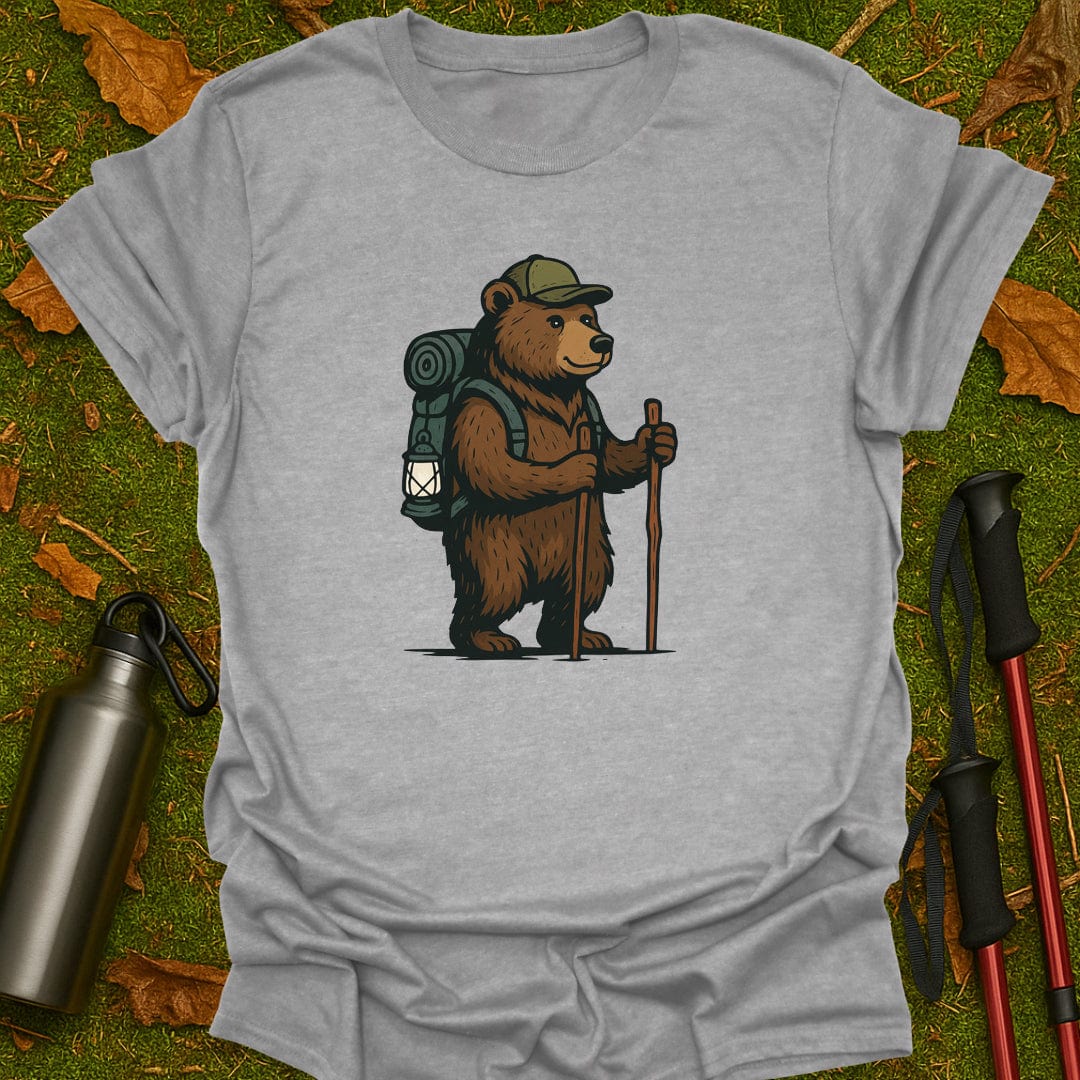 Gray t-shirt with a bear graphic holding a lantern and walking stick on grass.