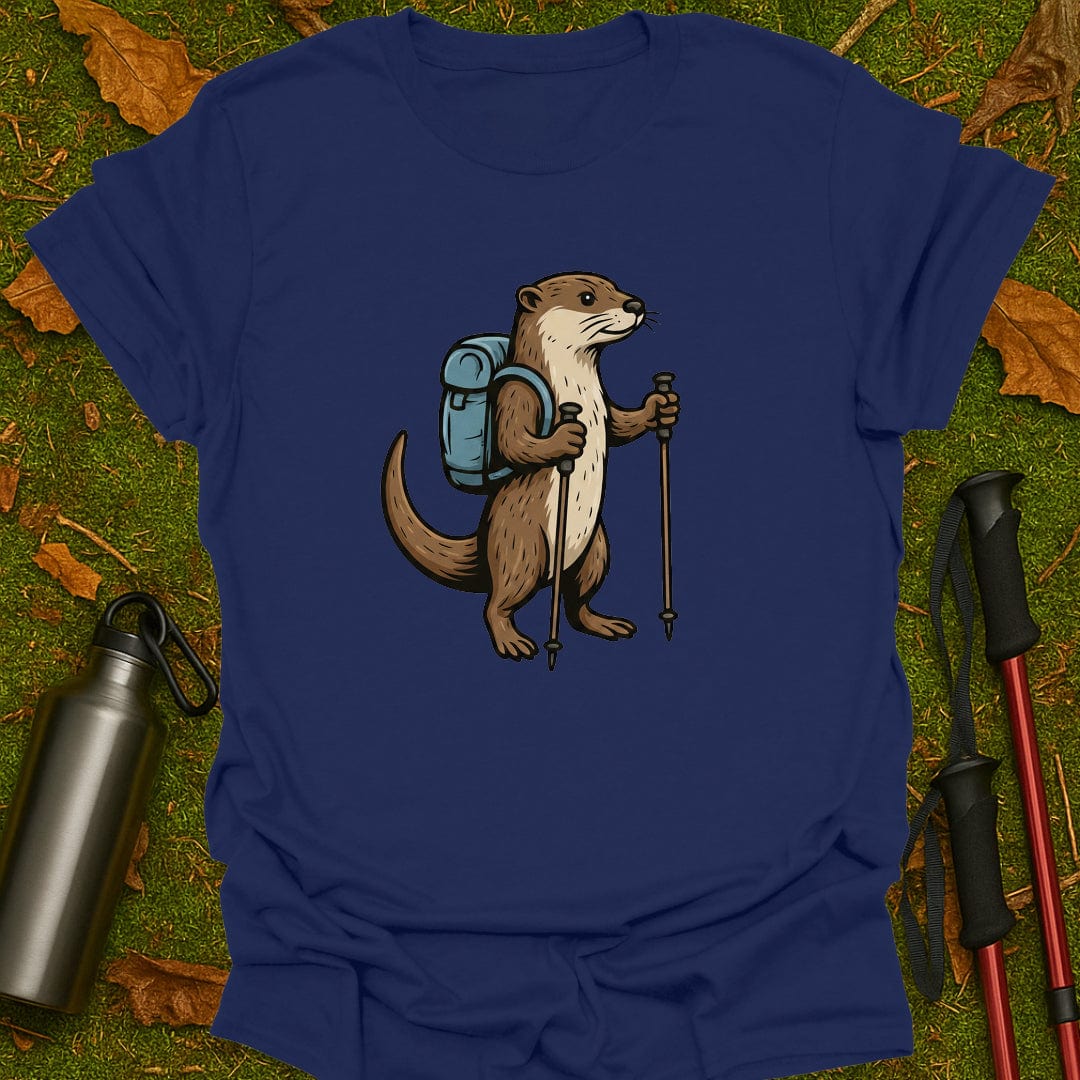 Blue t-shirt with an otter wearing a backpack and holding hiking poles on a grassy background.
