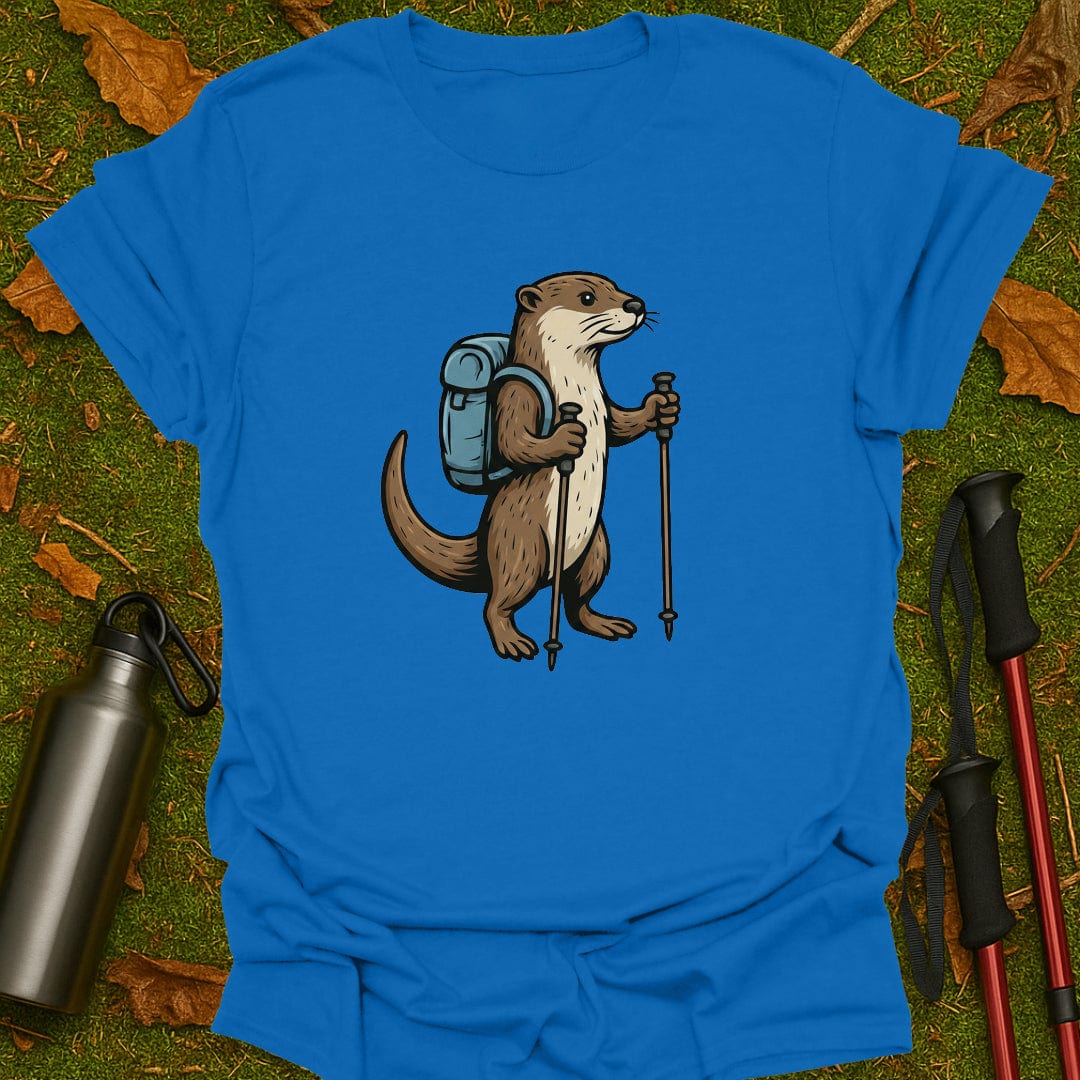Blue t-shirt with an otter design holding hiking poles and a backpack on a grassy background.