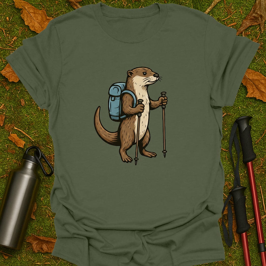 Green t-shirt with an otter wearing a backpack and holding hiking poles on grass.
